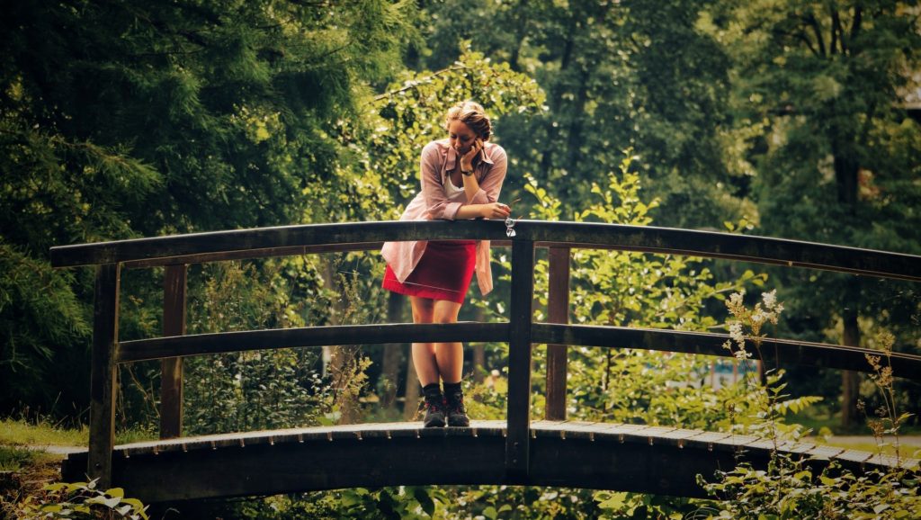 Contemplative writer on a bridge