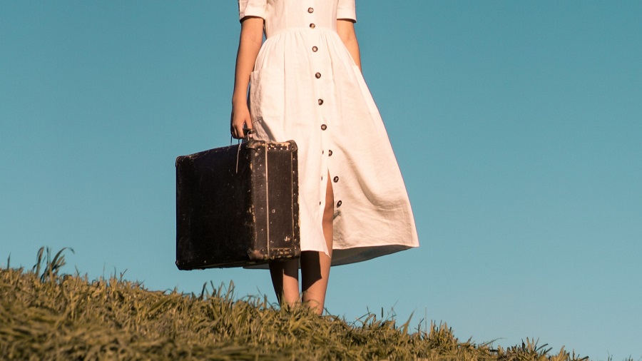 Girl on a Hill with Her Suitcase