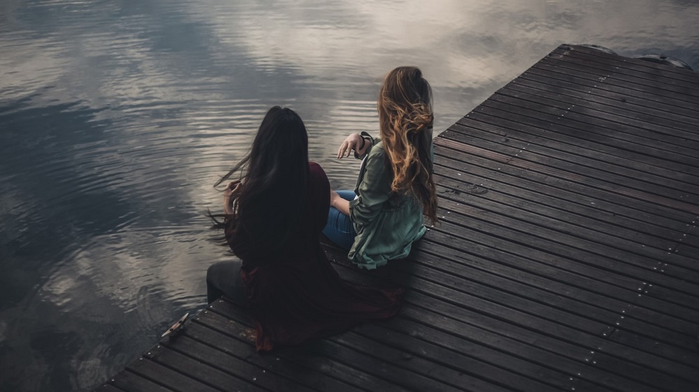 Two Girls Playing on a Pier