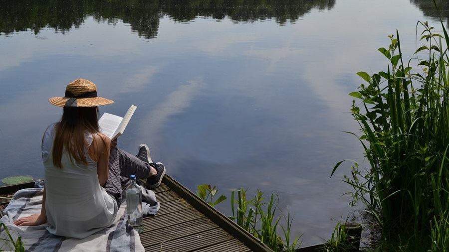 Girl Reading on a Dock