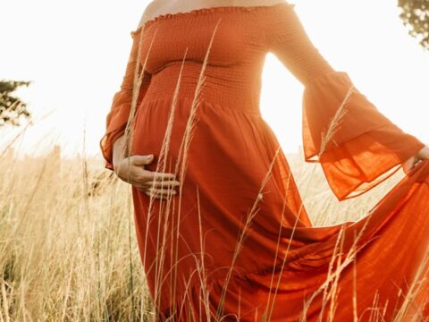 Pregnancy photo with red dress