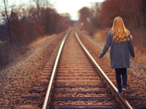 Redhead Walking Train Tracks