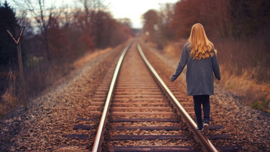 Redhead Walking Train Tracks