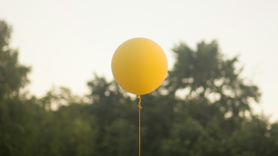 Yellow Balloon Against the Trees