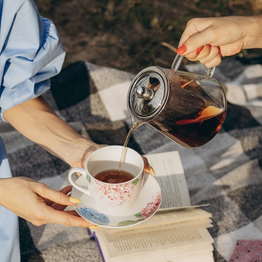 Friends Pouring a Cup of Tea