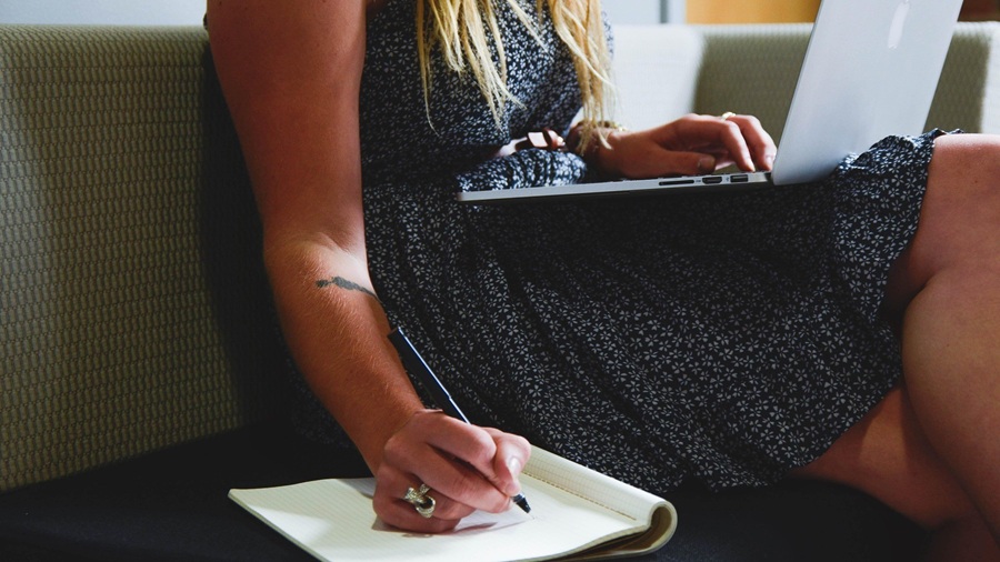 Woman Writing on her Laptop