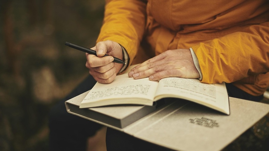 Hands Writing in a Journal